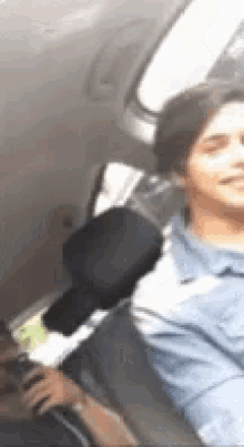 a woman is sitting in the back seat of a car .