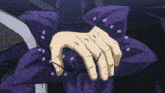 a man in a suit and tie holds a purple object in his hand