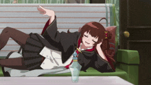 a girl laying on a couch with a bottle of water