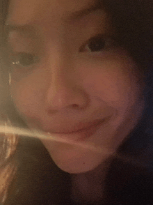 a close up of a woman 's face with a blurred background