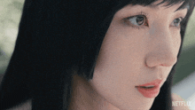 a close up of a woman 's face with netflix written on the bottom right