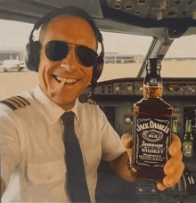 a man holding a bottle of jack daniels whiskey