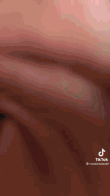 a close up of a person 's face with a tik tok watermark on the bottom .