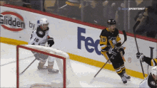 a hockey game is being played in front of a fedex sign