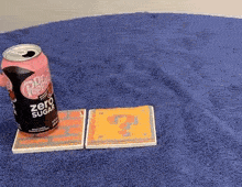 a can of dr. pepper zero sugar is sitting on top of a blue carpet .