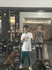 a man in a white shirt with the number 10 on it stands in a gym