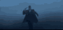 a man in a suit and tie is pointing a gun to his head