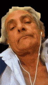 a man wearing ear buds looks at the camera