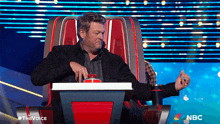 a man sitting in a chair with the word nbc on the bottom right
