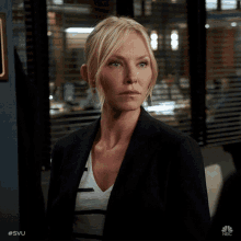 a woman standing in front of a window with the hashtag #svu on the bottom right