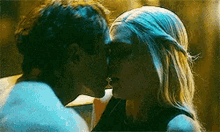 a man and a woman are kissing each other in a car .