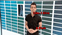 a man in a black shirt stands in front of a wall with the words like i give a fuck above him