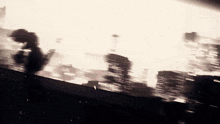 a blurred image of a city with a few buildings in the background