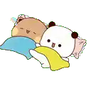 two teddy bears are laying next to each other on a bed with pillows .