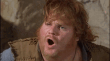 a man with red hair and a beard is making a funny face with his mouth open
