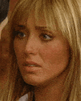 a close up of a woman 's face with her eyes closed