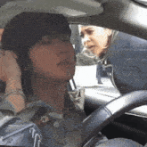 a woman sitting in a car talking on a cellphone