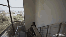 a woman is walking down a set of stairs that are made in animatica