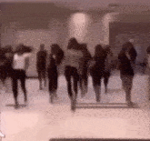 a group of people are dancing together in a room .