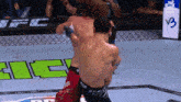 two men are fighting in a cage with a sign that says v3