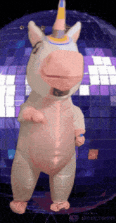 an inflatable unicorn is dancing in front of a disco ball made by unscreen