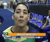 a female athlete named daniele hypolito is on a television screen