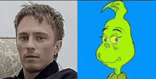 a man is sitting on a couch next to a picture of a grinch .