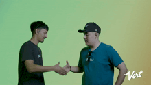 two men shaking hands with the word vert on the bottom right