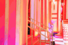 a blurred image of a staircase with the words sbs live on the bottom right