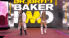 a couple of women standing next to each other on a red carpet in front of a large sign .