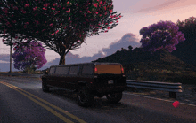 a black limousine is driving down a road with purple flowers