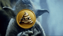 a coin with a poop face on it is being held by yoda