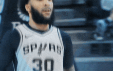 a man with a beard wearing a jersey with the number 30
