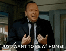 a man in a suit and tie is saying just want to be at home !