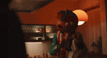 a person dressed in a tomato costume with the letter t on their chest