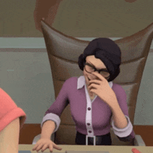 a woman in a purple shirt and glasses is sitting at a desk with her hand on her nose .