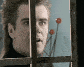 a man with a mullet looks out a window with a surprised look on his face