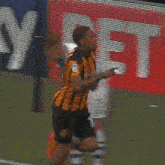 a soccer player wearing a yellow and black striped jersey with the number 7 on it