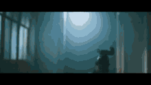 a person standing in a dark room with a light coming through the window