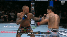 two men are fighting in a boxing ring with the ufc logo visible