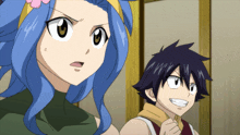 a boy and a girl are standing next to each other and the girl has a flower in her hair
