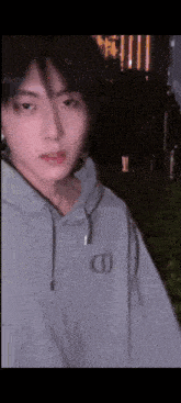 a close up of a person wearing a grey hoodie