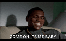 a man is smiling with the words come on its me baby behind him