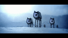 a group of dogs that look like at at walkers are standing in the snow