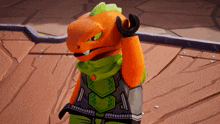 a toy lizard with orange and green arms is standing on a wooden surface