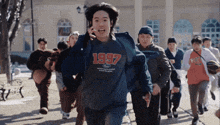 a man wearing a shirt that says 1997 is running