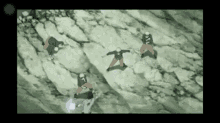 a group of people standing on top of a rocky hill