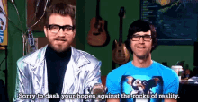 two men are standing next to each other and one has a gremlins shirt on