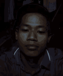 a close up of a man 's face in the dark