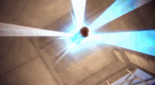 a basketball is being thrown into the air with a blue light behind it